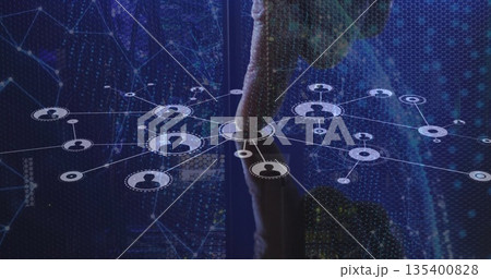 Touching male finger selecting central node on holographic network interface, with hexagonal grid 135400828