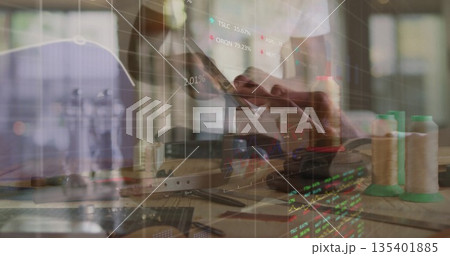 Interacting man in white T-shirt checking fabric with touchscreen in studio, with market overlays Interacting man in white T-shirt checking fabric with touchscreen in studio, with market overlays 135401885