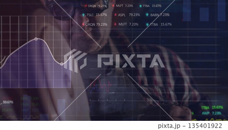 Studying stock trends, analyst wearing denim apron in lab with holographic screen displaying charts Studying stock trends, analyst wearing denim apron in lab with holographic screen displaying charts 135401922
