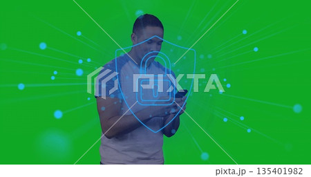 Man wearing grey tee holding smartphone and showcasing security in studio, with padlock overlay Man wearing grey tee holding smartphone and showcasing security in studio, with padlock overlay 135401982