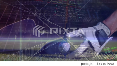 Positioning gloved hand gripping club head behind ball at golf tee, with financial graph overlays 135401998