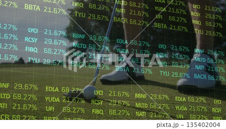 Putting golfer in white shoes striking golf ball with putter on putting green, with ticker overlays 135402004