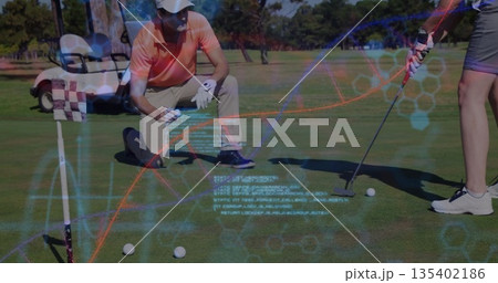 Kneeling instructor aligning putt on putting green, woman holding putter, with holographic data 135402186