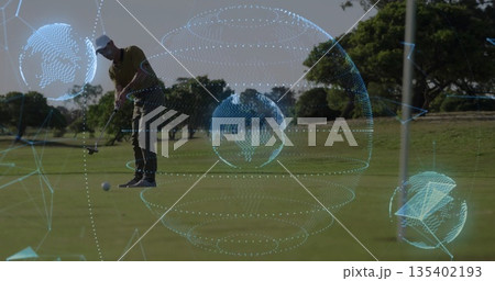 Leaning golfer wearing olive polo lining ball and aligning putter on putting green, with overlays 135402193
