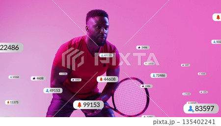 Bending into tennis stance man wearing red tee holding racket in studio, with notification overlays Bending into tennis stance man wearing red tee holding racket in studio, with notification overlays 135402241