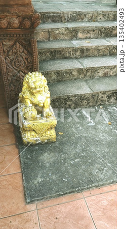 statue of a guardian lion is located at the base of the stairs. 135402493