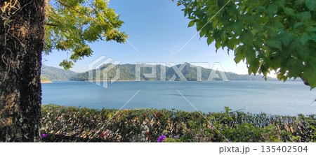 Scenic dam view with mountains in the background Scenic dam view with mountains in the background 135402504