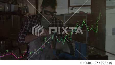 Grinding craftsman sharpening metal at workshop, with grinder, apron and chart overlay, copy space 135402730