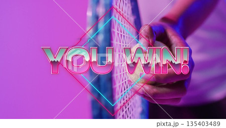 Clutching hand around yellow tennis ball against net in studio, with neon diamond, YOU WIN overlay Clutching hand around yellow tennis ball against net in studio, with neon diamond, YOU WIN overlay 135403489