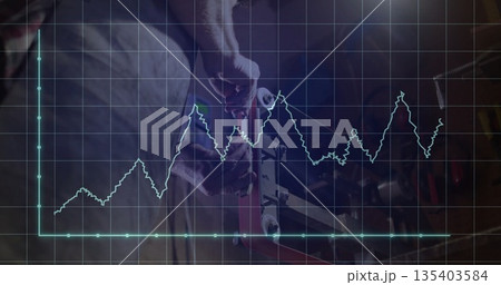 Mechanic wearing gloves and apron tightening vise bolt in workshop, line graph overlay, copy space 135403584