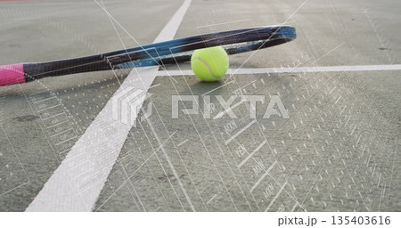 Resting pink-gripped tennis racket and neon green ball on white-lined court, featuring digital grid 135403616