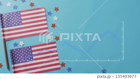 Displaying two American flags on sticks lying on tabletop, with confetti, line chart, copy space 135403677