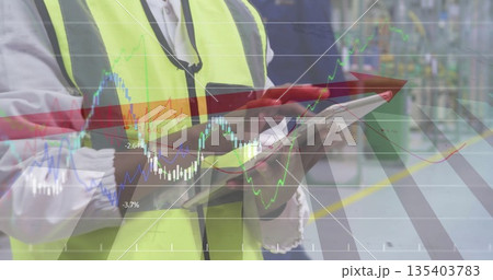 Monitoring supervisor in neon vest using stylus on tablet at assembly line with metrics overlay Monitoring supervisor in neon vest using stylus on tablet at assembly line with metrics overlay 135403783
