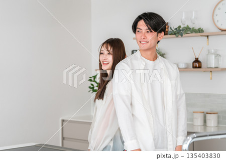 マイホームのキッチン・ダイニングに並ぶ夫婦・カップル・恋人・パートナー マイホームのキッチン・ダイニングに並ぶ夫婦・カップル・恋人・パートナー 135403830
