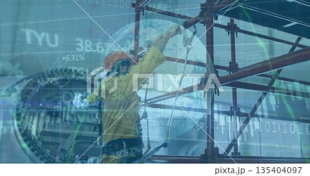 Factory worker in coverall adjusting harness tether on red scaffolding in plant with data overlays 135404097