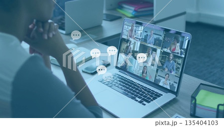 Joining woman in grey top connecting with remote team at office desk, with laptop, copy space 135404103