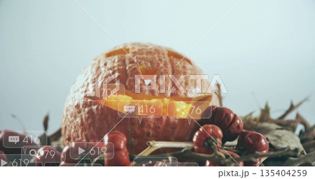 Carved pumpkin with social media notifications image over autumn decorations Carved pumpkin with social media notifications image over autumn decorations 135404259