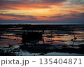 Silhouette long tail boat parking on the beach in the morning with sunrise sky and horizontal line in background 135404871