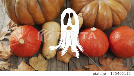Ghost image over pumpkins and autumn leaves on wooden surface Ghost image over pumpkins and autumn leaves on wooden surface 135405116