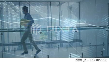 Masked Chinese man walking holding yellow folder past glass railing hallway, data chart, copy space Masked Chinese man walking holding yellow folder past glass railing hallway, data chart, copy space 135405365