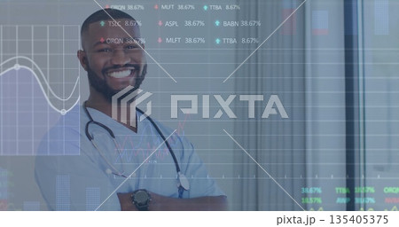 Smiling doctor wearing scrubs and stethoscope in office, vertical blinds, data overlay, copy space 135405375