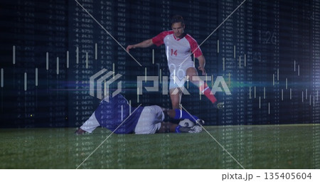 Dribbling player wearing red jersey, cleats pushing ball on grass field under lights, data overlay Dribbling player wearing red jersey, cleats pushing ball on grass field under lights, data overlay 135405604