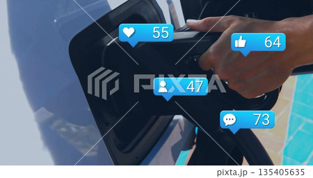 Connecting black EV charger into white car port at poolside patio, with blue social icons 135405635