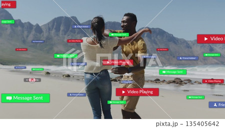 Couple dancing and embracing at sandy shoreline, with floating green, red and blue notifications 135405642