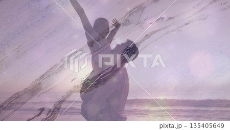 Couple lifting woman above his head in sandy beach at sunset, with ocean waves, glitch overlays Couple lifting woman above his head in sandy beach at sunset, with ocean waves, glitch overlays 135405649