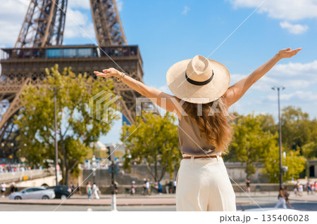 Joyful Woman with Outstretched Arms at Eiffel Tower Joyful Woman with Outstretched Arms at Eiffel Tower 135406028
