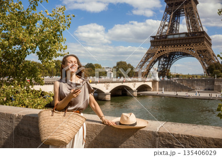 Smiling Traveler by Seine with Eiffel Tower View 135406029
