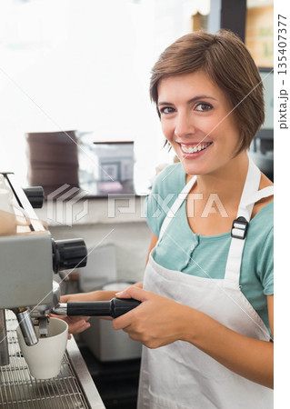 Woman using espresso maker at cafe counter, inserting portafilter, extracting espresso, copy space Woman using espresso maker at cafe counter, inserting portafilter, extracting espresso, copy space 135407377
