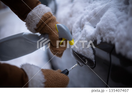 Unlocking a Frozen Car Door with De-Icing Spray Unlocking a Frozen Car Door with De-Icing Spray 135407407