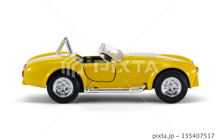 Miniature yellow toy racing car on white background 135407517