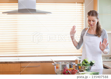 White home cook lifting and preparing vegetables in colander by pot in kitchen, copy space 135407588