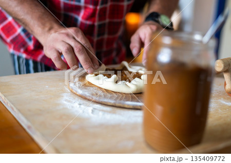 Detail of hands of men rolling the dough. Preparation for baking of traditional czech pastry. Homemade fresh food Detail of hands of men rolling the dough. Preparation for baking of traditional czech pastry. Homemade fresh food 135409772