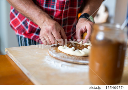 Detail of hands of men rolling the dough. Preparation for baking of traditional czech pastry. Homemade fresh food Detail of hands of men rolling the dough. Preparation for baking of traditional czech pastry. Homemade fresh food 135409774