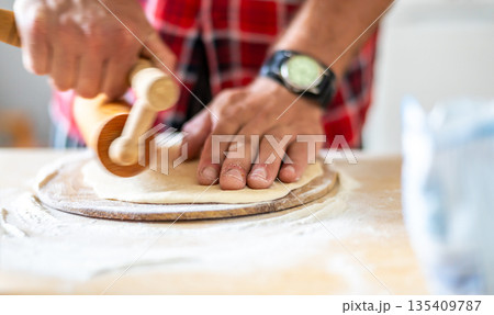 Detail of hands of men rolling the dough. Preparation for baking of traditional czech pastry. Homemade fresh food Detail of hands of men rolling the dough. Preparation for baking of traditional czech pastry. Homemade fresh food 135409787