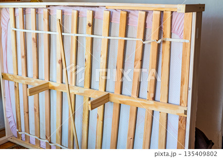 View of bottom part of wooden bed and the frame. View of bottom part of wooden bed and the frame. 135409802