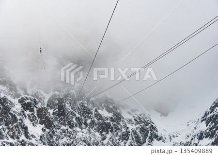 Cable car to Lomnicky stit peak, High Tatras region, Slovakia. Winter and cloud weather. 135409889