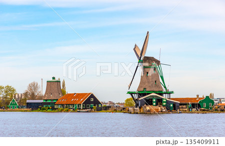 Traditional windmills over at the Zaanse Schans, cloudy weather 135409911