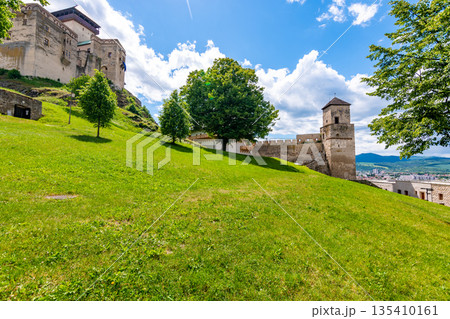 Ancient castle Trencin, Slovakia. Old fort on the hill, big walls and towers. Summer day, dramatic clouds before storm. Ancient castle Trencin, Slovakia. Old fort on the hill, big walls and towers. Summer day, dramatic clouds before storm. 135410161