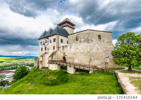Ancient castle Trencin, Slovakia. Old fort on the hill, big walls and towers. Summer day, dramatic clouds before storm. Ancient castle Trencin, Slovakia. Old fort on the hill, big walls and towers. Summer day, dramatic clouds before storm. 135410164