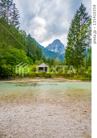 The Krumme Steyr river near the village Hinterstoder and famous lake Schiederweiher. Pure fresh water near Austrian Alps and mountains peaks. Soft colors, peace in nature. The Krumme Steyr river near the village Hinterstoder and famous lake Schiederweiher. Pure fresh water near Austrian Alps and mountains peaks. Soft colors, peace in nature. 135410359