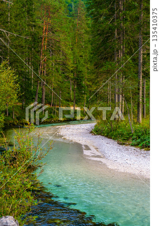 The Krumme Steyr river near the village Hinterstoder and famous lake Schiederweiher. Pure fresh water near Austrian Alps and mountains peaks. Soft colors, peace in nature. The Krumme Steyr river near the village Hinterstoder and famous lake Schiederweiher. Pure fresh water near Austrian Alps and mountains peaks. Soft colors, peace in nature. 135410375