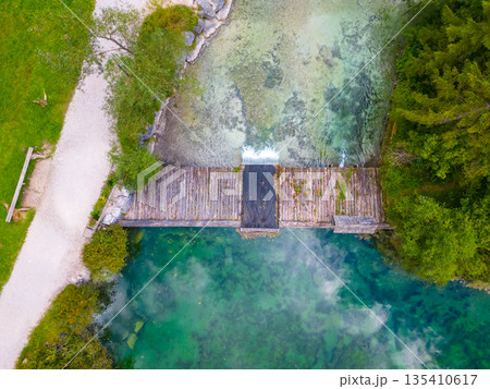 Schiederweiher in Hinterstoder top bottom drone aerial view to small dam and flowing water Schiederweiher in Hinterstoder top bottom drone aerial view to small dam and flowing water 135410617