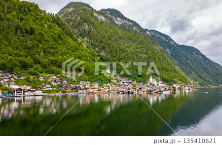 Aerial view of austrian mountain village Hallstatt and Hallstatter lake. Beautiful summer time. Salzkammergut, Austria. Hallstatt village over Hallstatter See, in Salzkammergut, Austria. 135410621