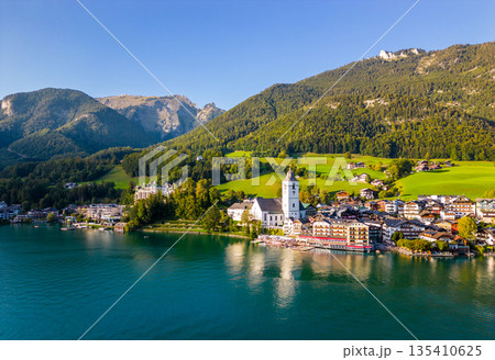 Beautiful aerial view of the popular village of Sankt Wolfgang im Salzkammergut. Alpine mountains, church and Wolfgangsee. Upper Austria, Salzburg. Beautiful aerial view of the popular village of Sankt Wolfgang im Salzkammergut. Alpine mountains, church and Wolfgangsee. Upper Austria, Salzburg. 135410625