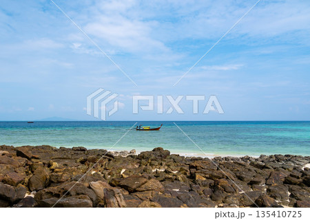 Long tailed boats near tropical beach at Ko Phi Phi, Thailand. Tropic beach with white sand and turquoise water, concept of vacation in paradise. 135410725