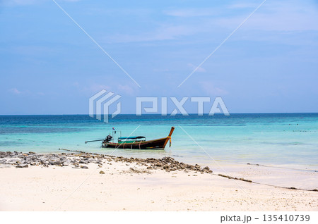 Long tailed boats near tropical beach at Ko Phi Phi, Thailand. Tropic beach with white sand and turquoise water, concept of vacation in paradise. 135410739